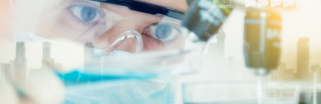 HCP that wears mask and glasses looking out a window.